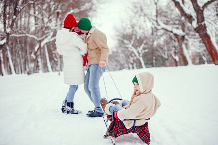 Family with cute daughters in a winter park