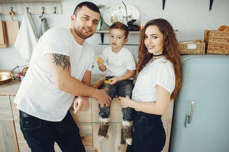 Loving family sitting in a kitchen at homeの写真素材