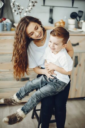 Loving family sitting in a kitchen at homeの写真素材