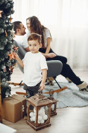 Loving family at home near christmas decorationsの写真素材