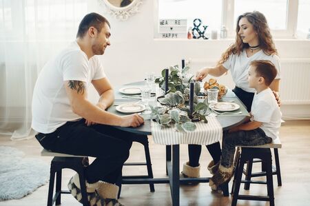 Loving family sitting in a kitchen at homeの写真素材