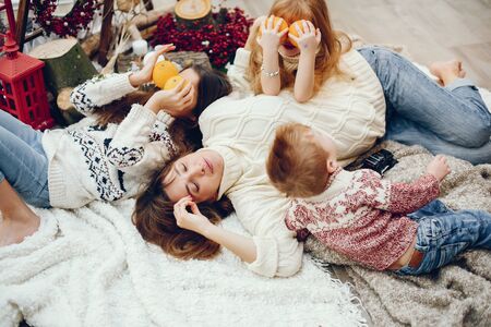 Beautiful mother with children. Family at home. People in a Christmas decorations.