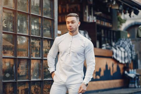 Handsome businesman in a summer cityの写真素材