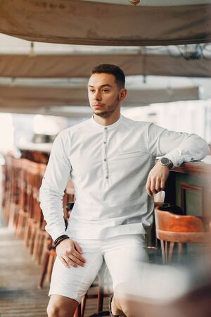 Handsome businesman in a summer cityの写真素材