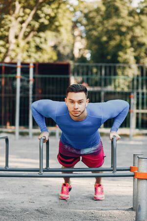 Handsome man training in a summer parkの写真素材