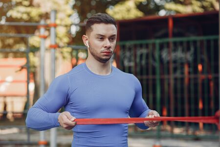 Handsome man training in a summer park