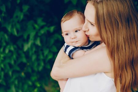 Mom and son relax in the park.の写真素材