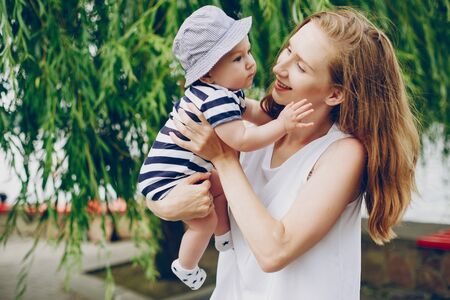 Mom and son relax in the park and walking around the river.
