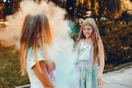 Two cute girls have fun in a summer parkの写真素材