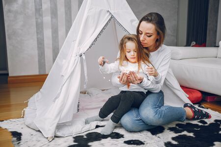 Mother with little daughter at homeの写真素材