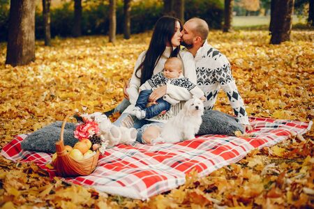 Family with son in a autumn parkの写真素材