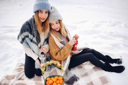 Two cute girls in a winter parkの写真素材