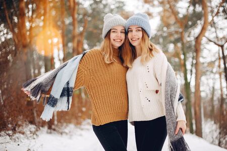 Two cute girls in a winter parkの写真素材