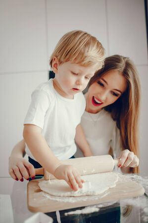 Mother and son cook the dough for cookies
