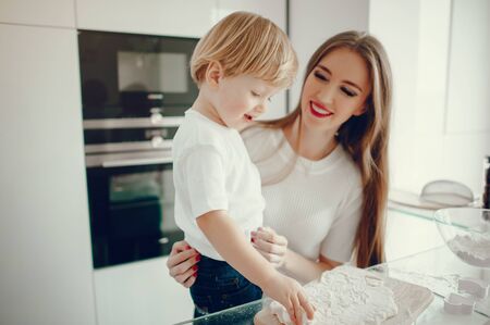 Mother and son cook the dough for cookiesの写真素材