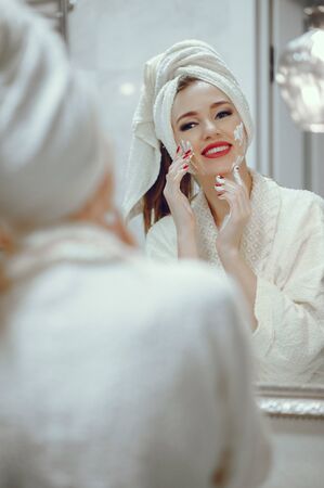 Beautiful woman standing in a bathroomの写真素材