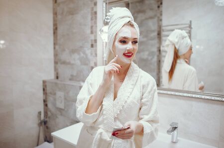 Beautiful woman standing in a bathroomの写真素材