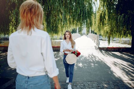 Mother with young daughter in a summer parkの写真素材