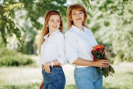 Mother with young daughter in a summer parkの写真素材
