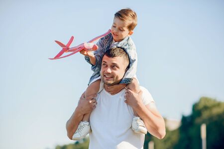 Cute family playing in a summer parkの写真素材