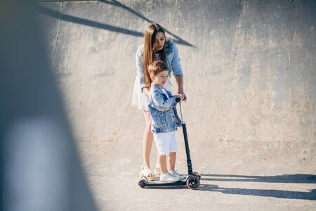 Mother with son playing in a summer parkの写真素材