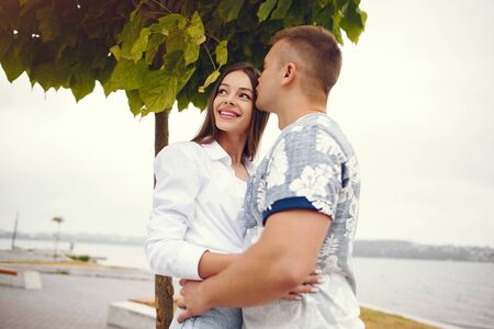 Beautiful couple spend time in a autumn cloudy park
