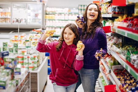 Mother with a daughter in a supermarketの写真素材