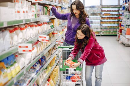 Mother with a daughter in a supermarketの写真素材