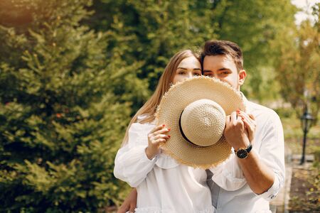 Beautiful couple spend time in a summer parkの写真素材