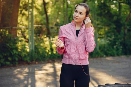 Sports girl training ain a summer park