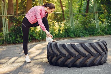Beautiful girl in a park. Sports girl in a sportswear.の写真素材