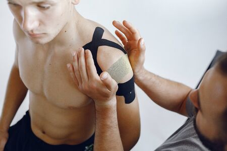 Doctor glues a tepee to an athlete at the hospitalの写真素材