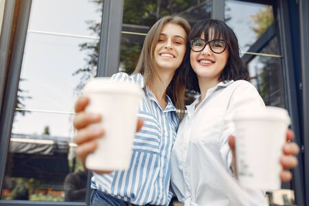 Fashion girls standing in a summer cityの写真素材