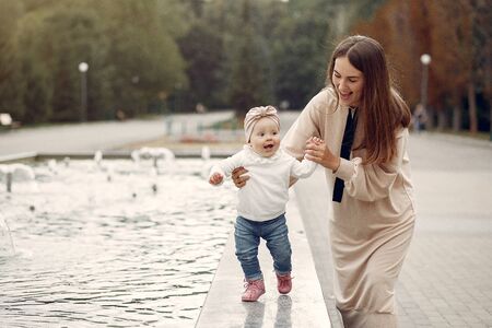 Mother with little child spend time in a parkの写真素材