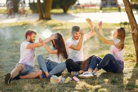 People have fun in a park with holi paintsの写真素材