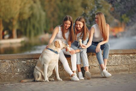 Girls sitting in a spring sity with cute dog