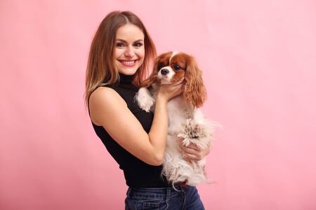 Fashion girl posing on a pink background