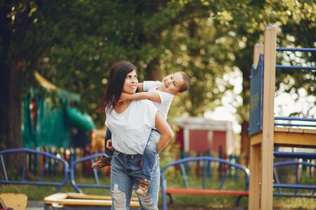 Mother with little child on a playgroundの写真素材