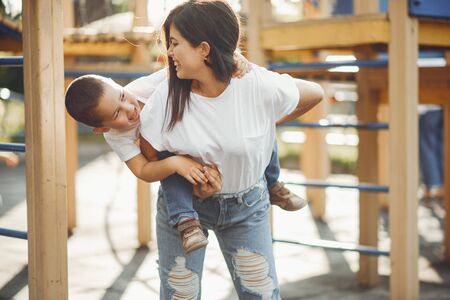 Mother with little child on a playgroundの写真素材