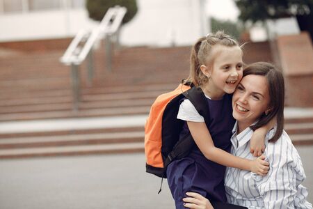 Mother prepare little daughter to schoolの写真素材