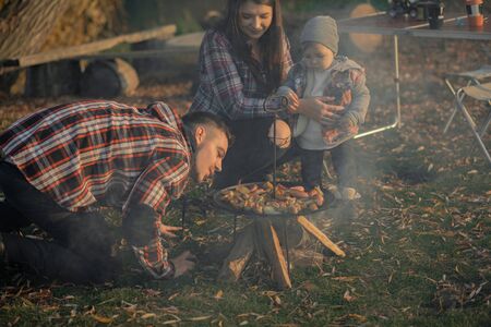 Cute family sitting on a picnic in a forestの写真素材