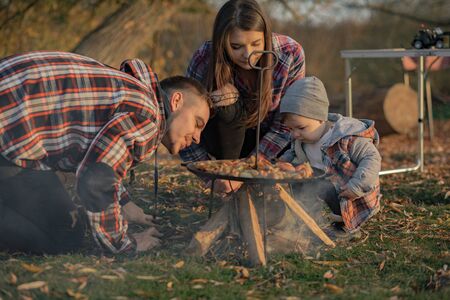 Cute family sitting on a picnic in a forestの写真素材