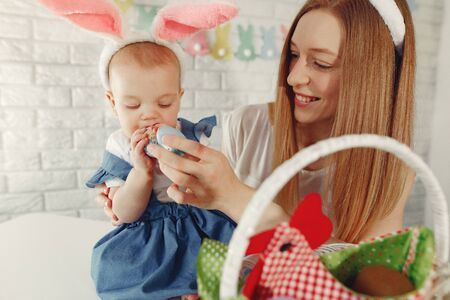 Mother with daughter in a kitchen prepare to easterの写真素材