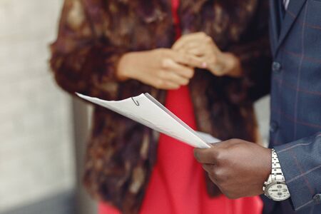 Black couple. Woman in a red dress. Man in a suit. Businesspeople.の写真素材