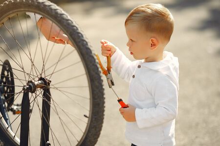 Father with son repare the bike in a parkの写真素材