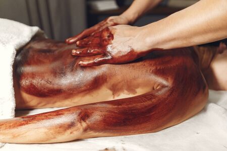 The doctor massages the woman with a chocolateの写真素材