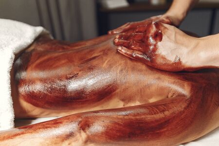 The doctor massages the woman with a chocolateの写真素材