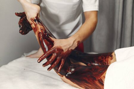 The doctor massages the woman with a chocolateの写真素材