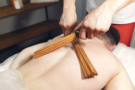 Massage doctor. The man is undergoing rehabilitationの写真素材