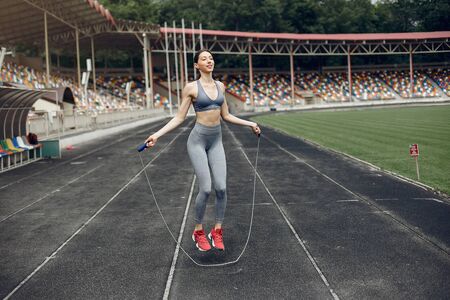 Sports girl training at the stadium